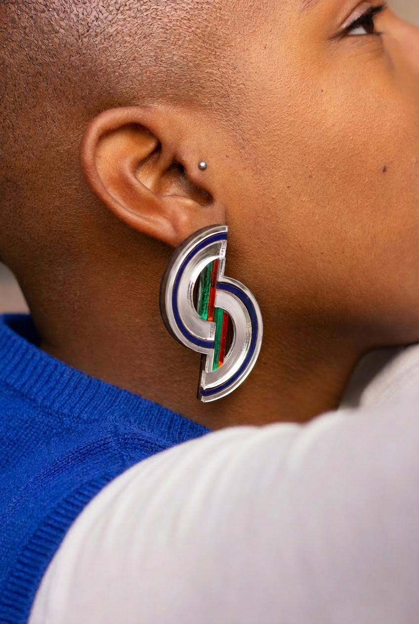 model wearing curved geometric barbican earrings
