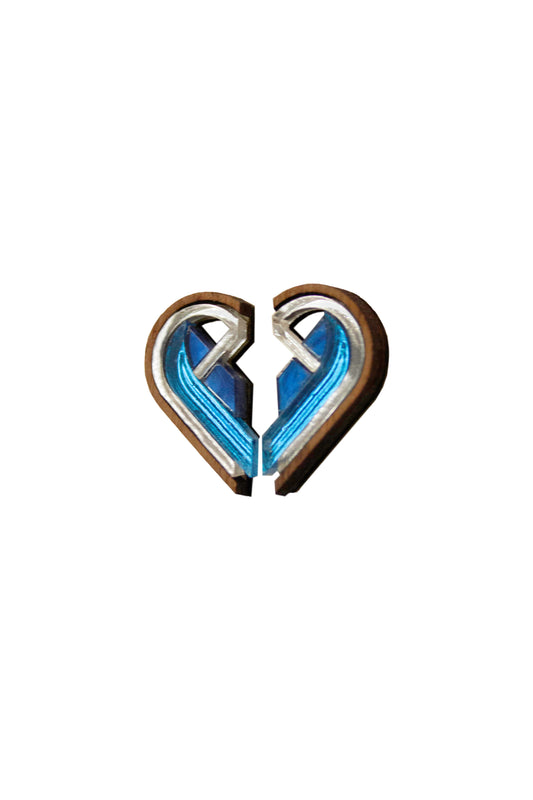 Two semi heart shaped blue and silver earrings joined together on a white background. Laser cut earrings made from acrylic, walnut wood and plywood.