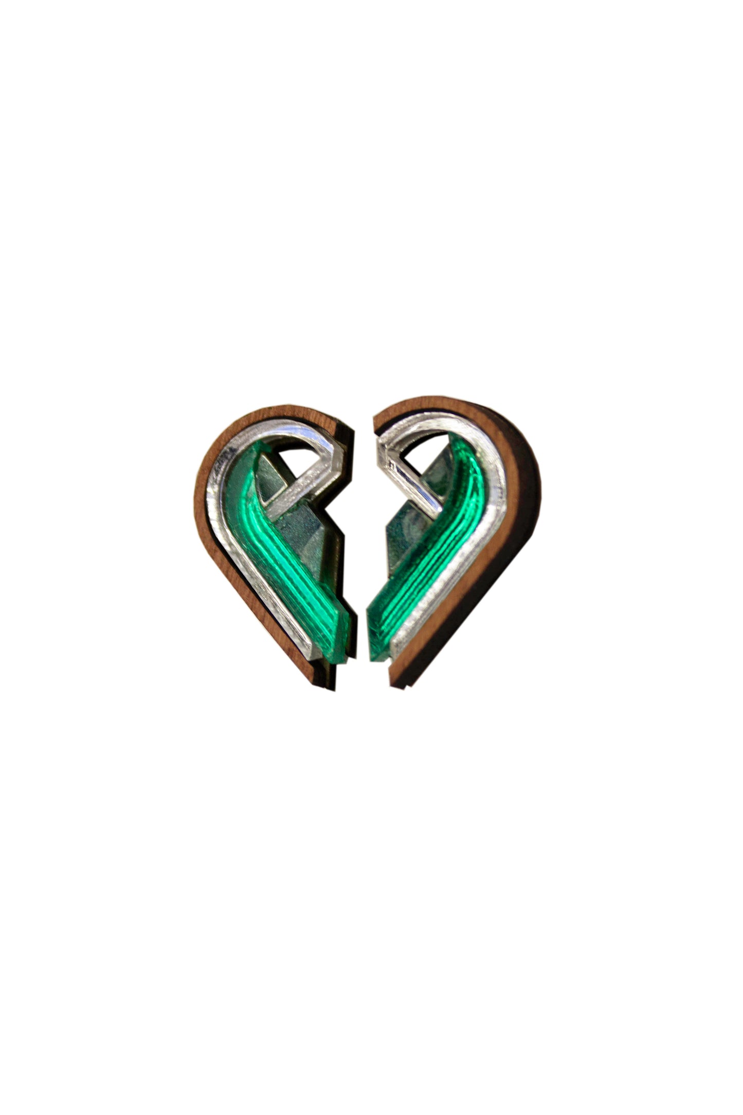 Two half-heart shaped earrings in green and silver joined together on a white background. Laser cut earrings made from acrylic, walnut wood and plywood