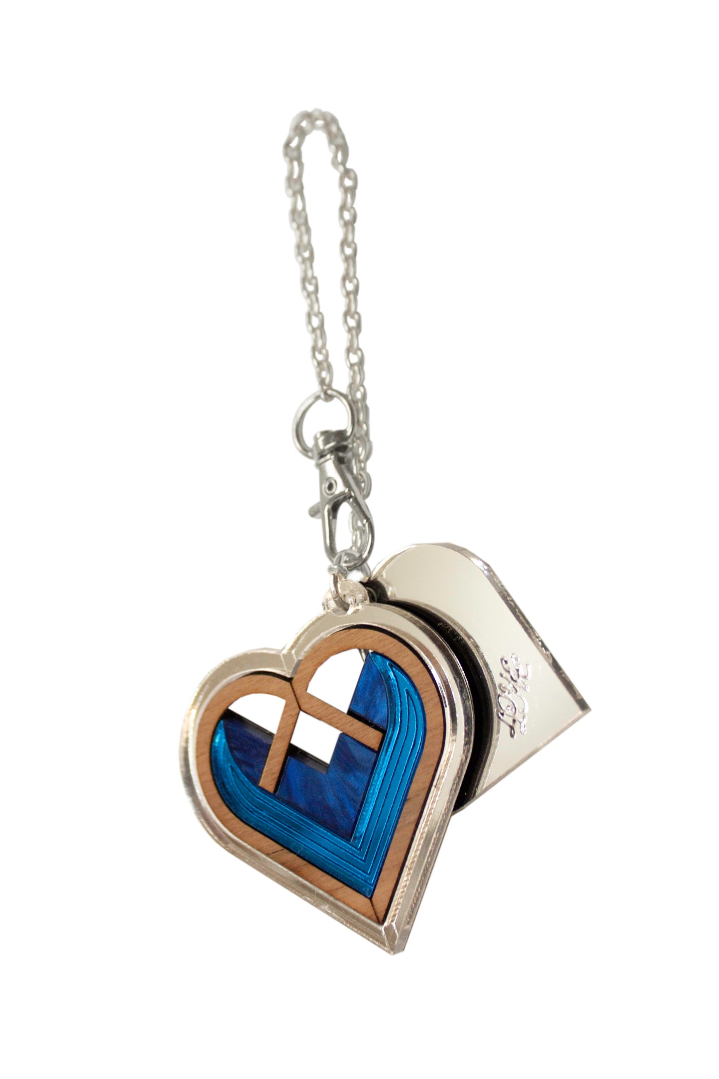 Heart-shaped bag charm with blue interior and silver accents on a white background. Laser cut bag charm made from acrylic, walnut wood and plywood