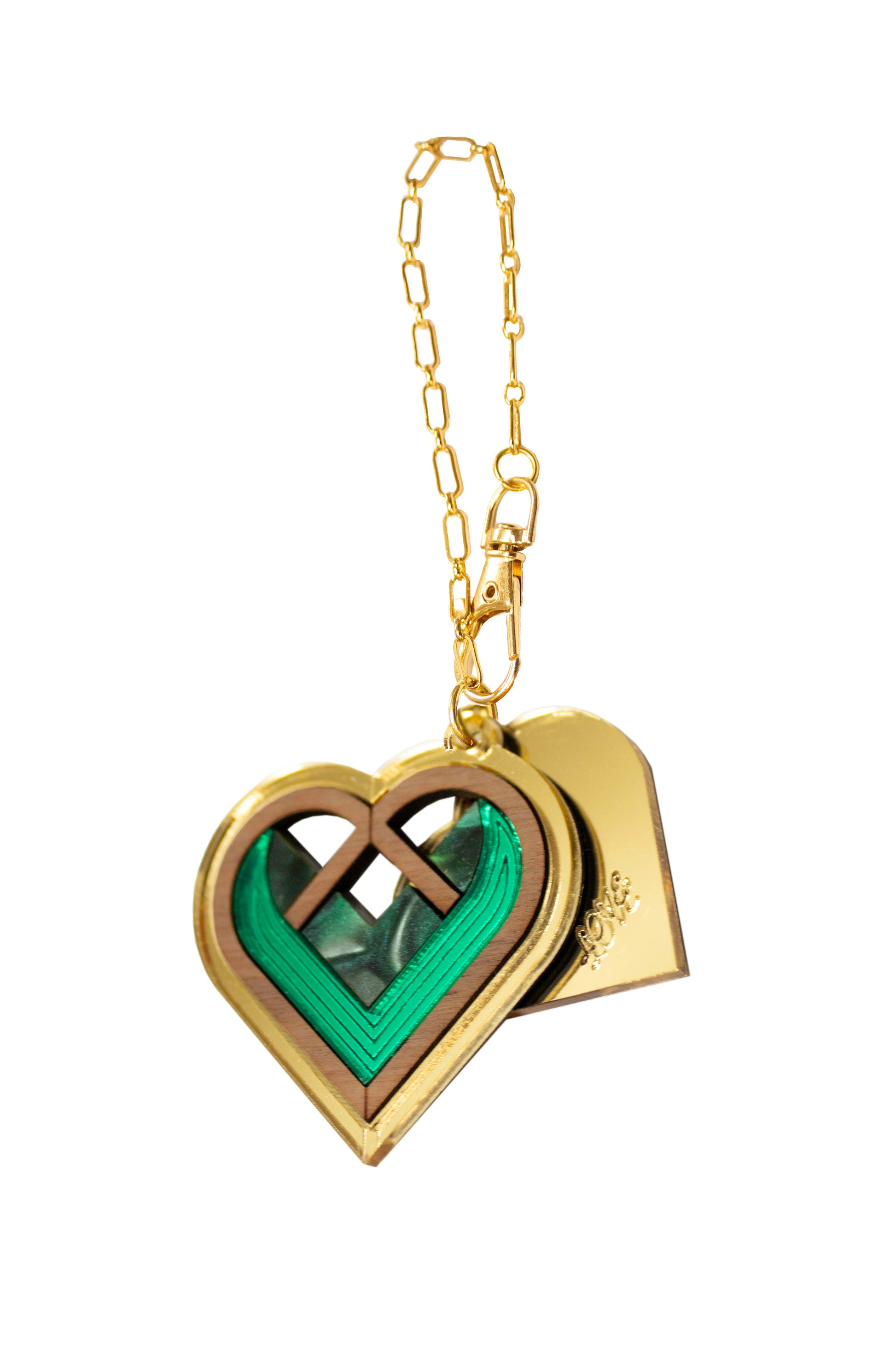 Heart-shaped bag charm with green interior and gold chain on a white background. Laser cut bag charm made from acrylic, walnut wood and plywood