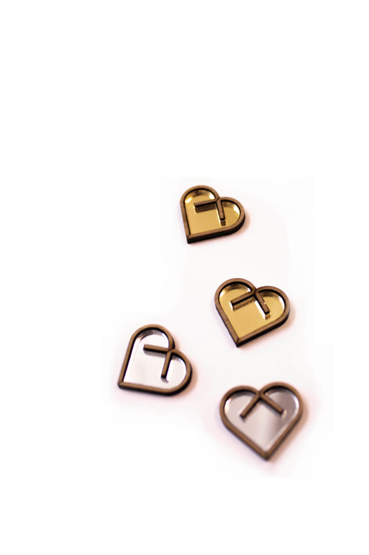 Four heart-shaped acrylic studs on a white background