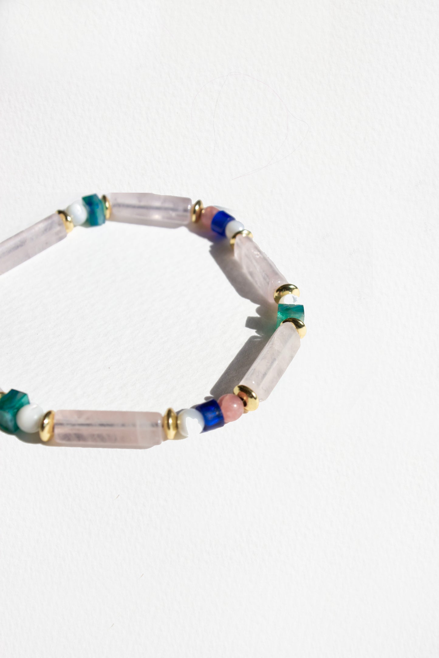 Beaded bracelet with multicolored beads on a white background