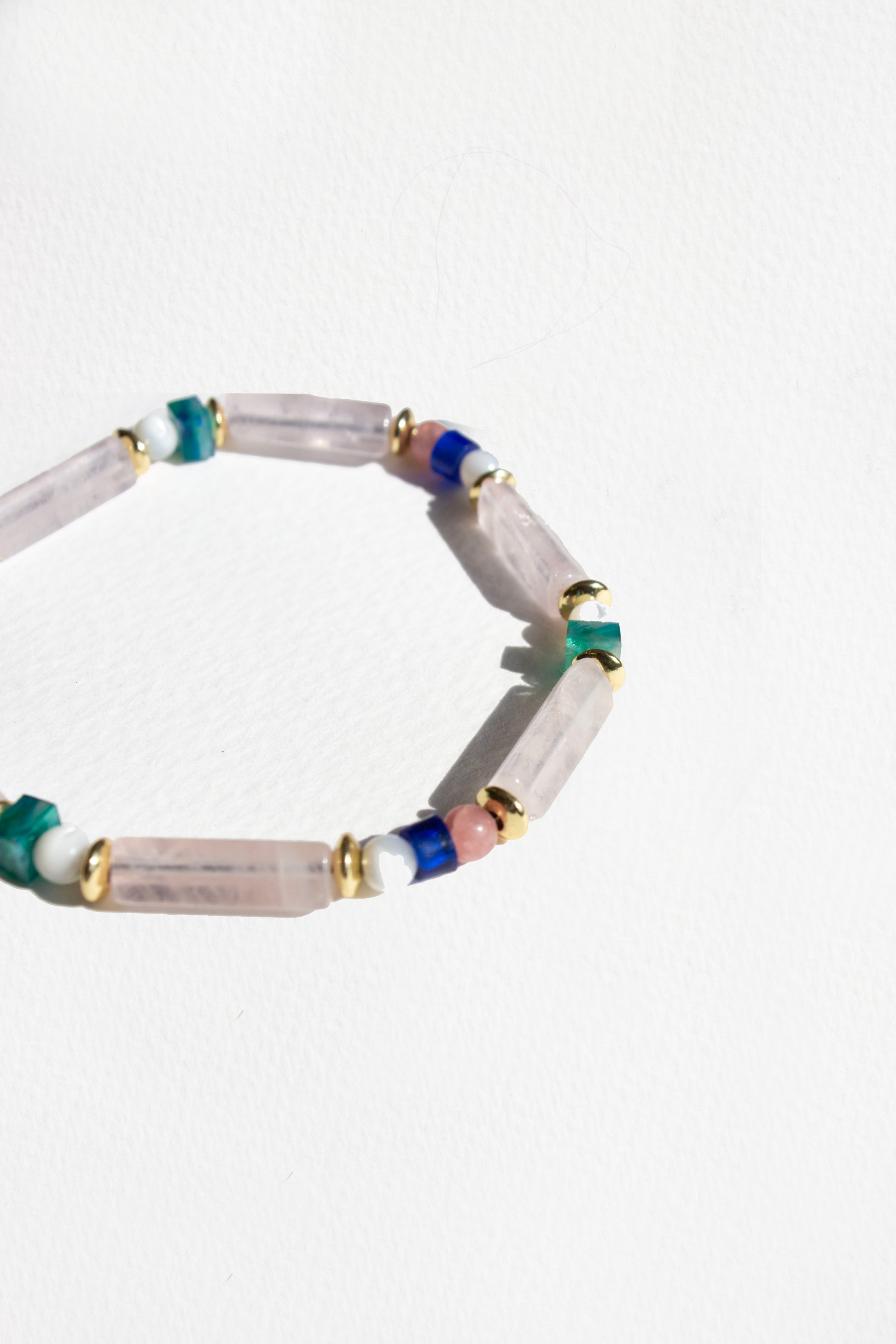 Beaded bracelet with multicolored beads on a white background