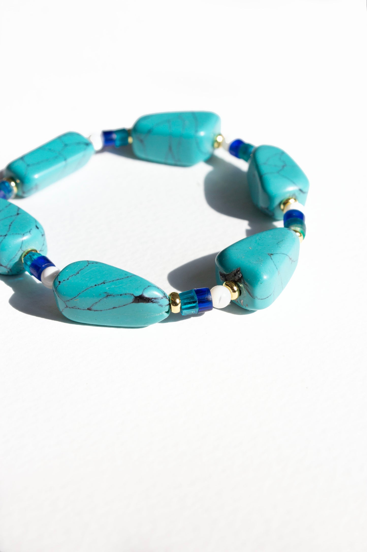 Turquoise beaded bracelet on a white background