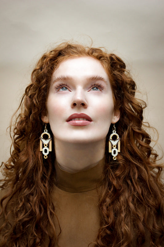 Women wearing Florence Earrings in regency and gold, architectural statement jewellery