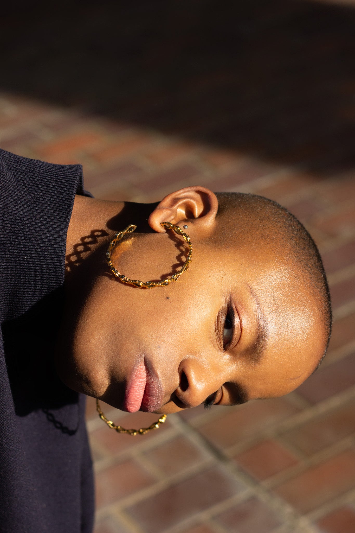 Large Gold Mayan hoops worn on model