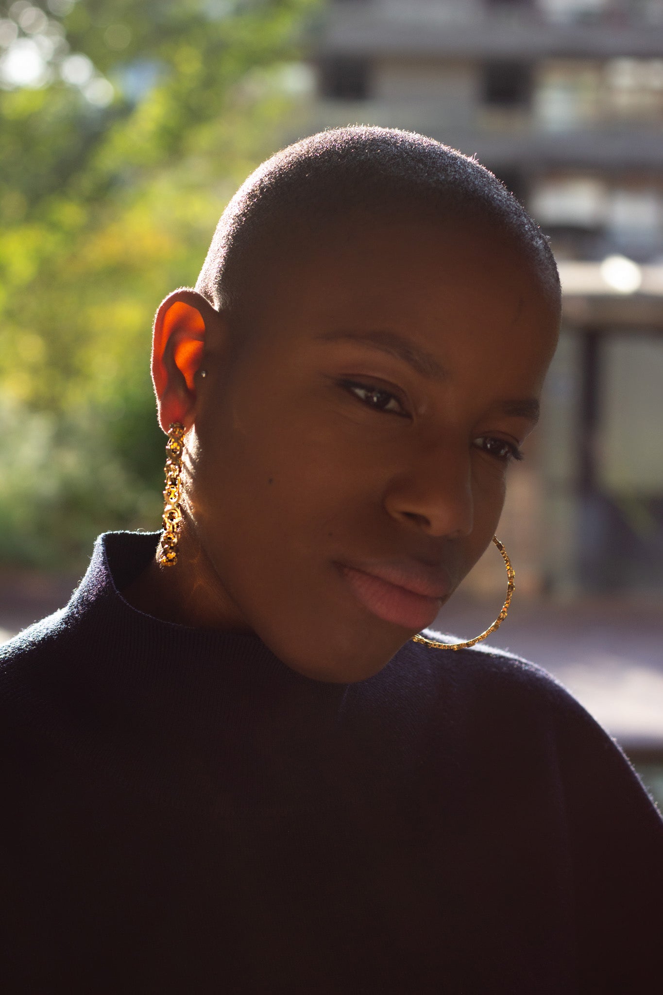 Large golden hoops worn on model