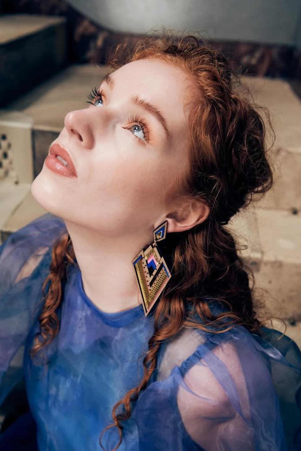 Woman wearing bold derin lasercut statement earrings