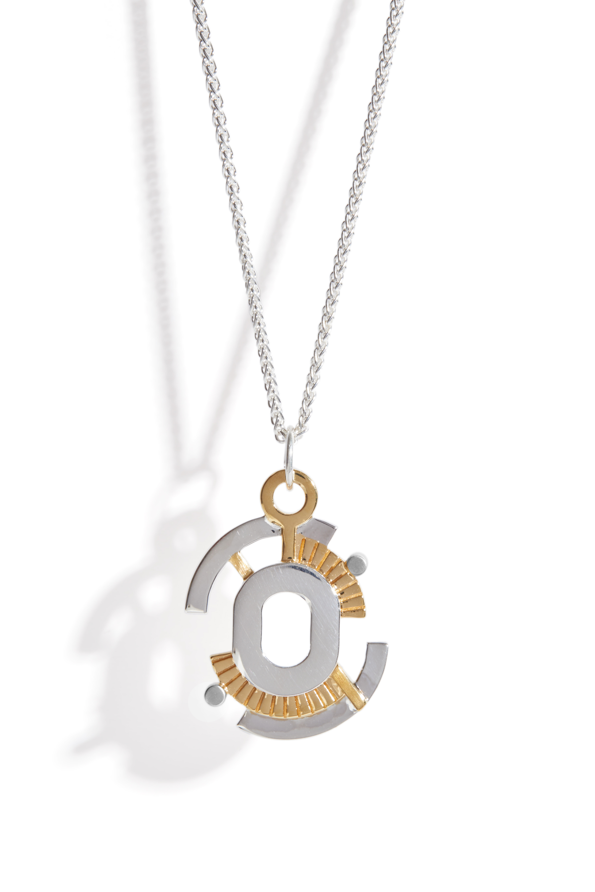 Geometric necklace with a silver and gold pendant on a white background. Silver plated pendant